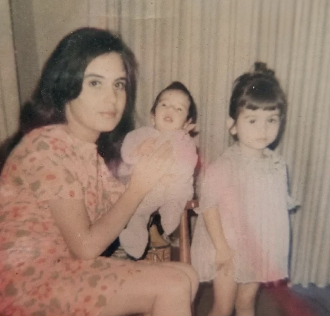 Elena holding baby Alex with young Adriana beside her